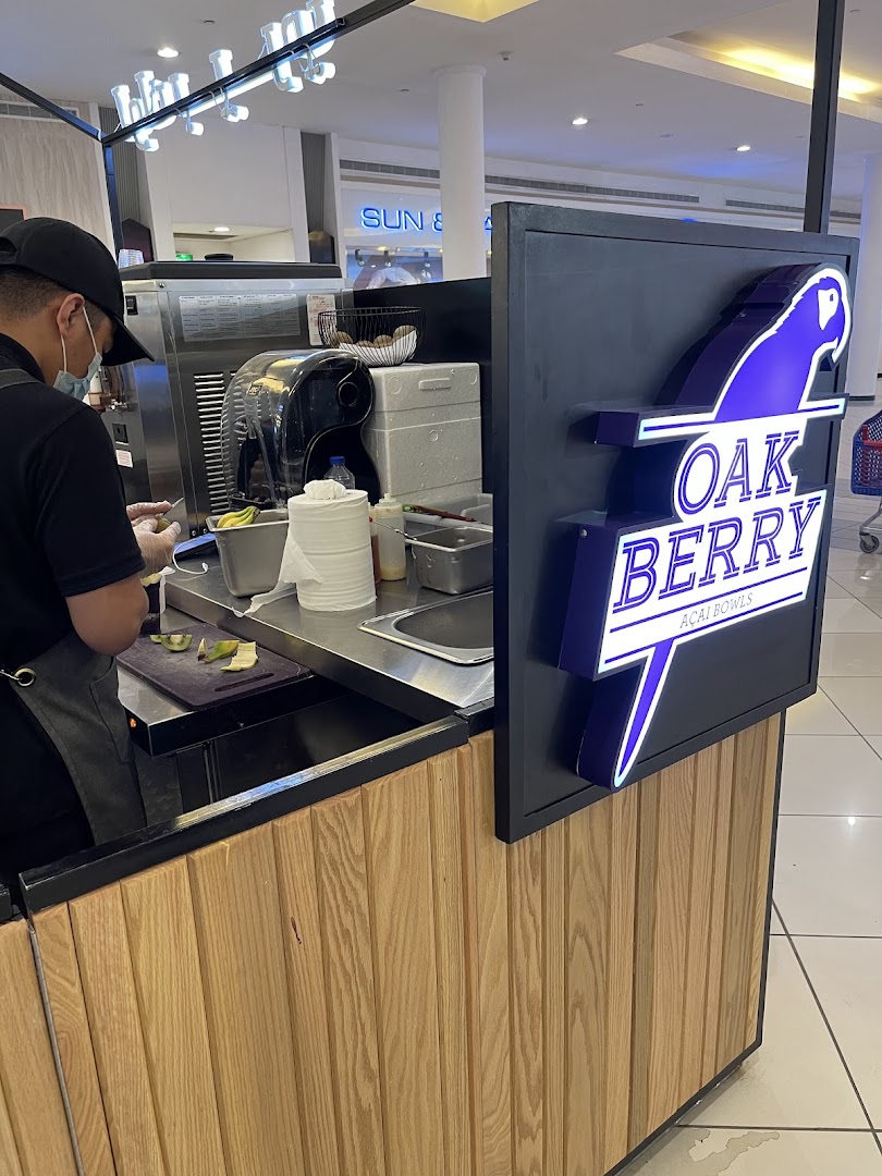A worker prepares acai bowls at the Oakberry Acai kiosk in a shopping mall.