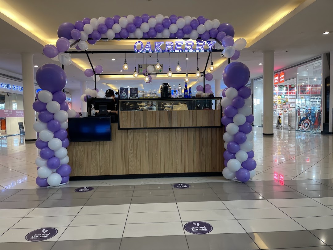 Oakberry Acai shop front decorated with purple and white balloons.