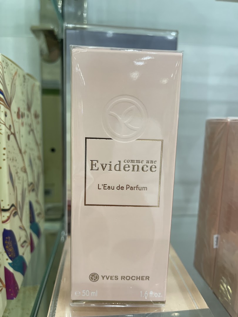 A close-up of an Yves Rocher 'Evidence' Eau de Parfum bottle on a shelf.