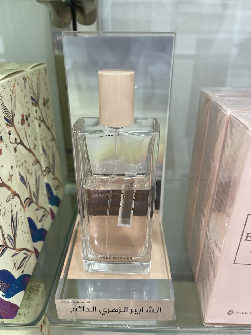 A bottle of Yves Rocher 'Evidence' Eau de Parfum is displayed on a shelf.