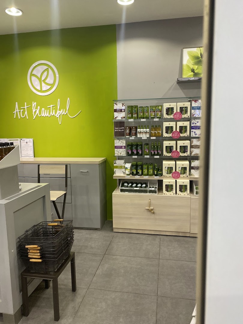 Interior view of an Yves Rocher shop with products displayed on shelves and the brand logo on the wall.