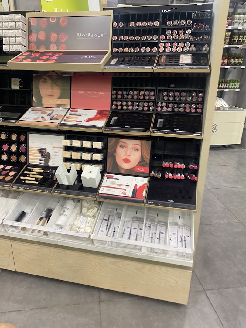A display of various makeup products, including lipsticks, foundations, and brushes, at Yves Rocher.