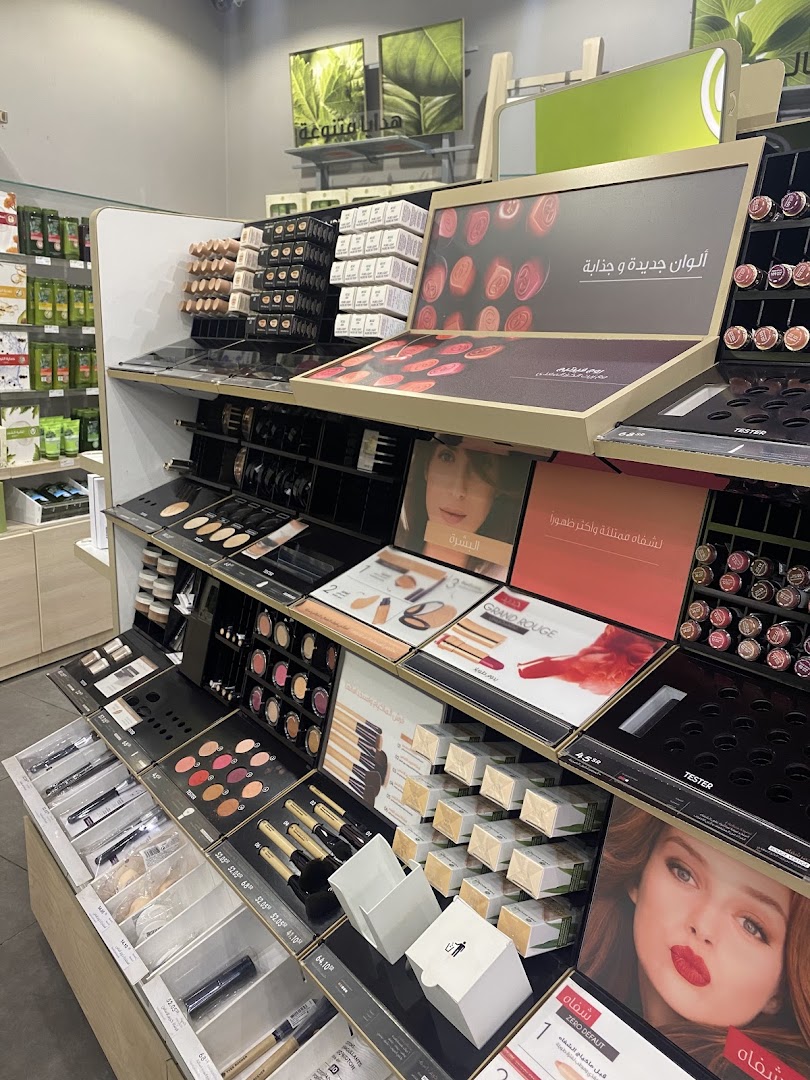 A well-organized display of makeup products, including lipsticks, eyeshadows, and brushes, at Yves Rocher.