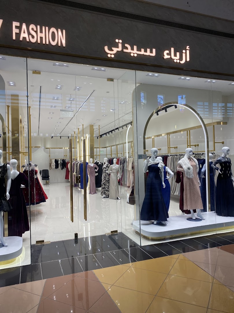 A fashion boutique with mannequins displaying elegant dresses and a well-lit interior.